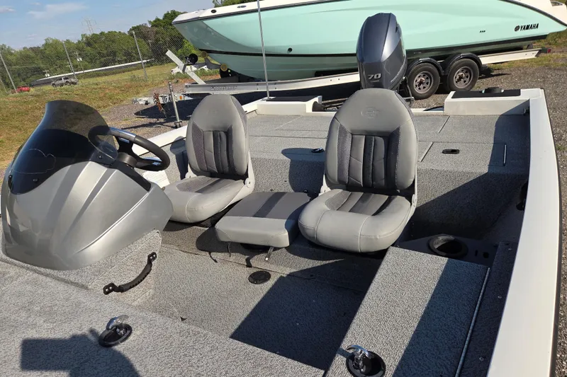 Slide: The Image of 2022 G3 Sportsman 1610 boat interior with steering console and seating. - 11