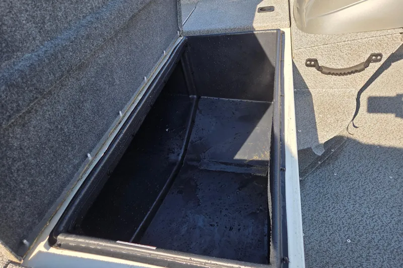 Slide: The Image of Open storage compartment in 2022 G3 Sportsman 1610 boat, featuring carpeted interior. - 13