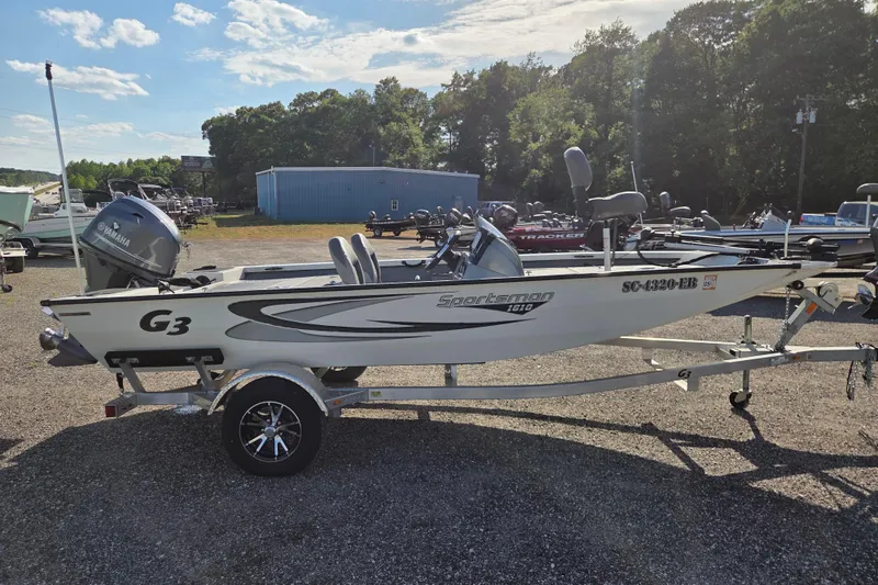 Slide: The Image of 2022 G3 Sportsman 1610 boat on trailer, parked outdoors under a clear sky. - 3