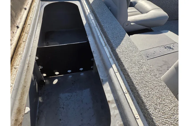 Slide: The Image of 2022 G3 Sportsman 1610 boat interior with storage compartment and seating. - 8