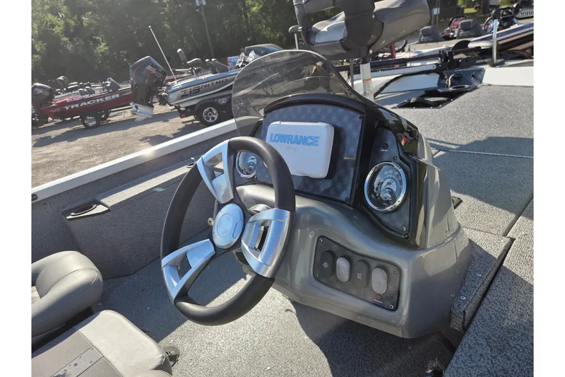 Slide: The Image of 2022 G3 Sportsman 1610 boat dashboard with steering wheel and Lowrance display. - 9