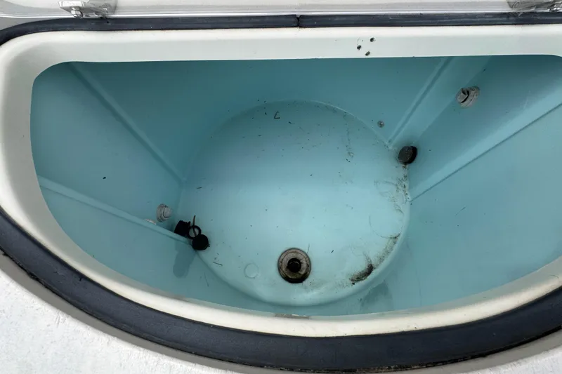 Slide: The Image of Livewell interior of a 2006 Pursuit 3480 Center Console boat, showing drainage and fittings. - 26