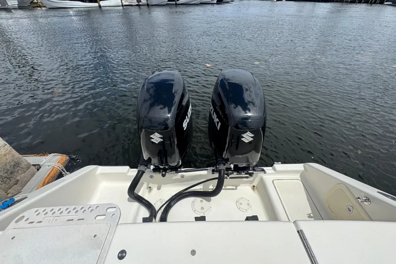 Slide: The Image of Twin Suzuki outboard motors on a 2006 Pursuit 3480 Center Console boat. - 7