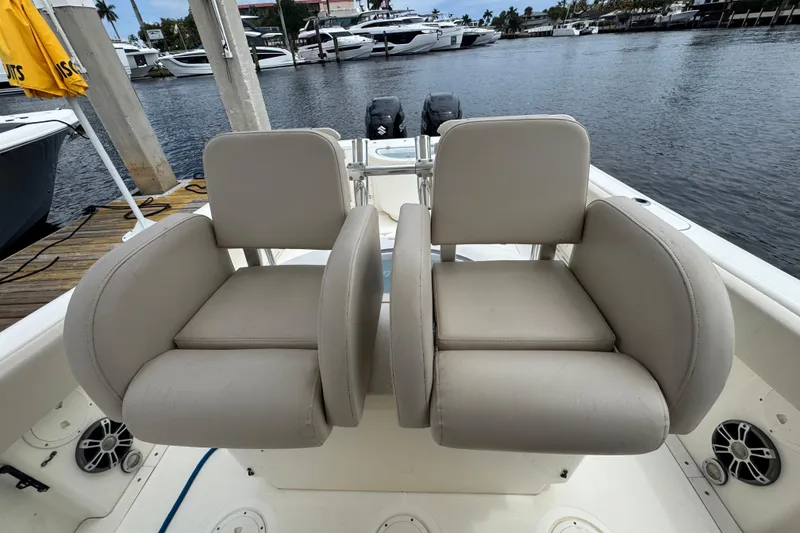 Slide: The Image of 2006 Pursuit 3480 Center Console boat seats with marina view in background. - 9