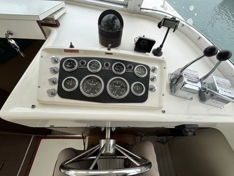 Slide: The Image of Dashboard of a 1978 Bertram MOPPIE boat with steering and instruments. - 13