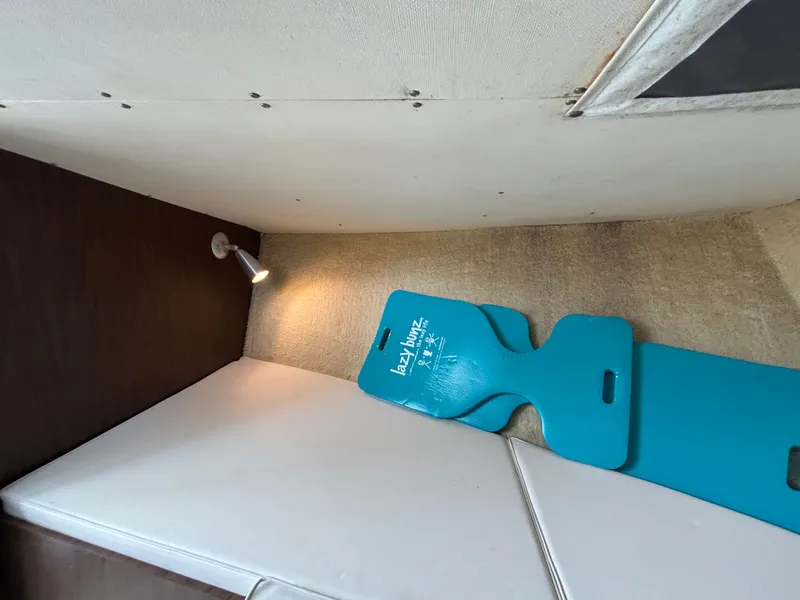 Slide: The Image of Interior of a 1978 Bertram MOPPIE with blue mat and reading light. - 16
