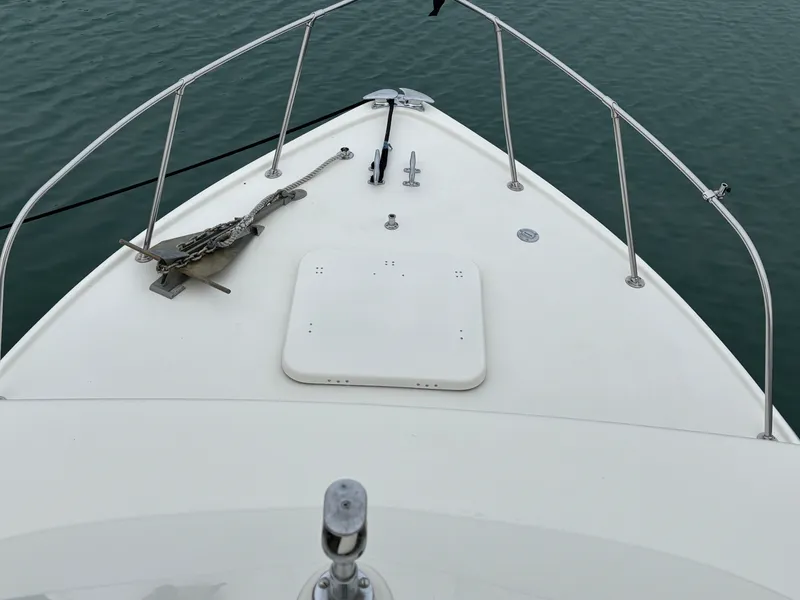 Slide: The Image of Bow of a 1978 Bertram MOPPIE boat on calm water. - 20