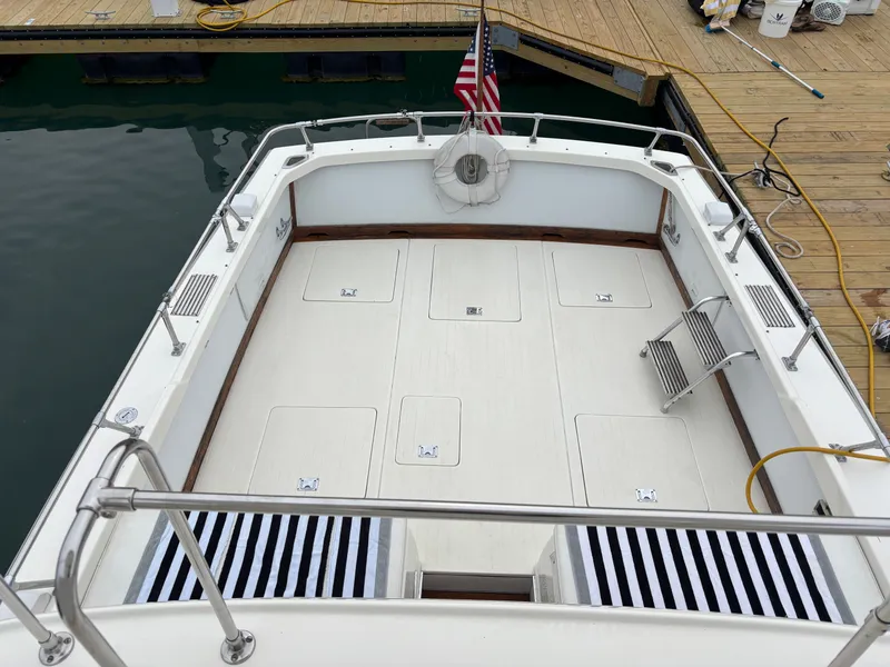 Slide: The Image of 1978 Bertram MOPPIE boat deck with American flag at dock. - 21