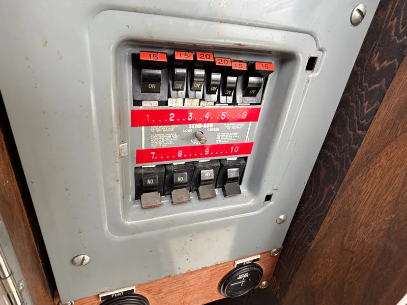 Slide: The Image of 1978 Bertram MOPPIE control panel with toggle switches and fuses. - 24