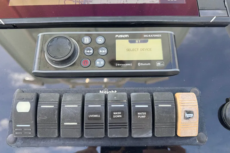 Slide: The Image of Control panel of a 2014 Tidewater 250 CC Adventure boat with Fusion audio system. - 12
