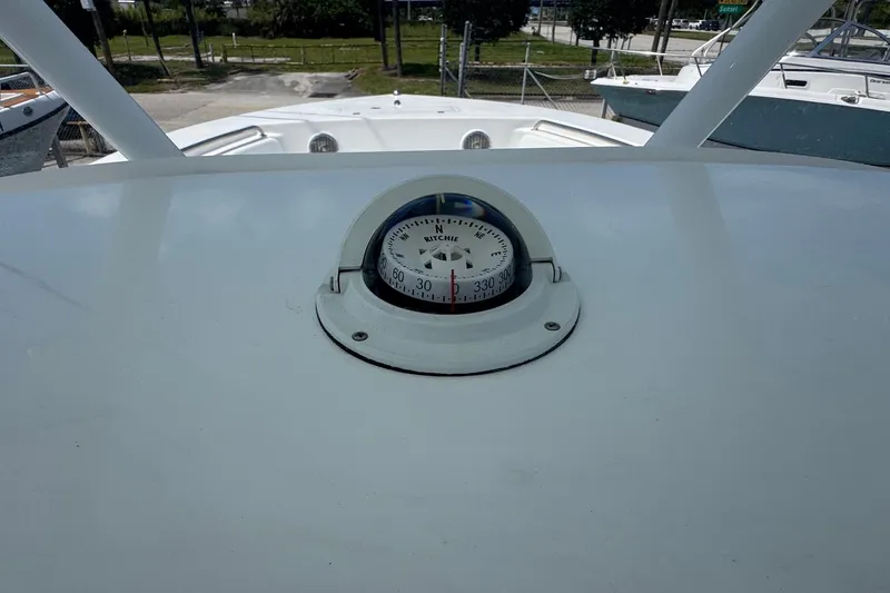 Slide: The Image of Compass on 2014 Tidewater 250 CC Adventure boat dashboard, outdoor setting. - 19