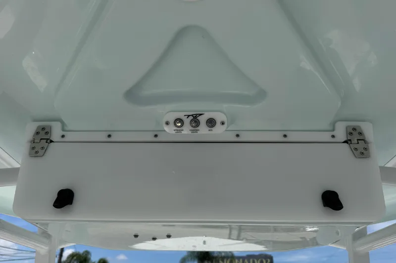 Slide: The Image of 2014 Tidewater 250 CC Adventure boat console with control panel and storage compartment. - 20
