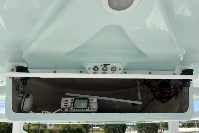 Slide: The Image of 2014 Tidewater 250 CC Adventure boat console with electronic equipment and wiring. - 21