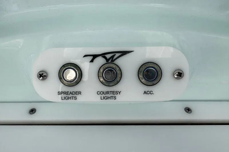 Slide: The Image of Control panel of a 2014 Tidewater 250 CC Adventure boat with light switches. - 23