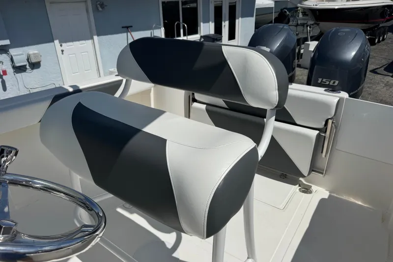 Slide: The Image of 2014 Tidewater 250 CC Adventure boat interior with dual engines and cushioned seating. - 25