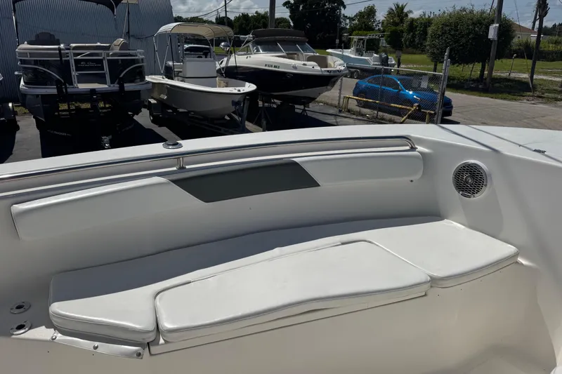 Slide: The Image of 2014 Tidewater 250 CC Adventure boat interior with white seating and speaker. - 29