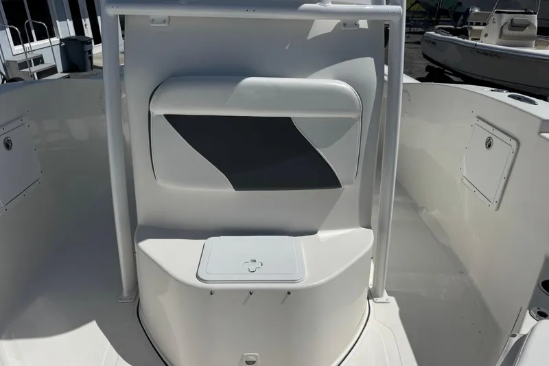 Slide: The Image of 2014 Tidewater 250 CC Adventure boat interior with seating and storage compartment. - 32
