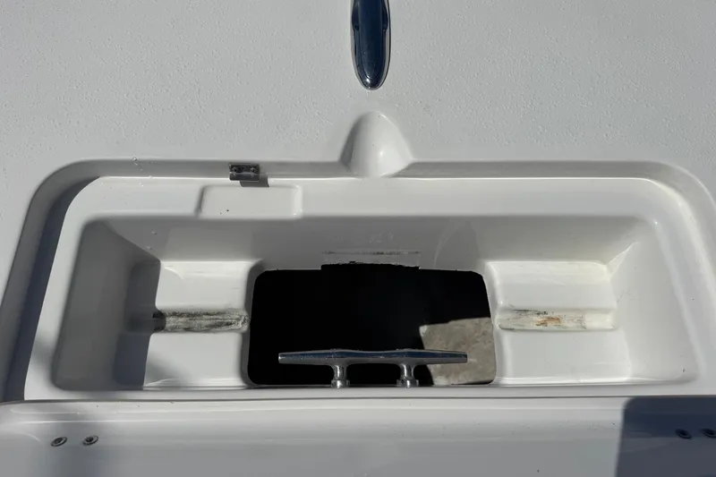 Slide: The Image of 2014 Tidewater 250 CC Adventure boat compartment with cleat, white interior. - 34