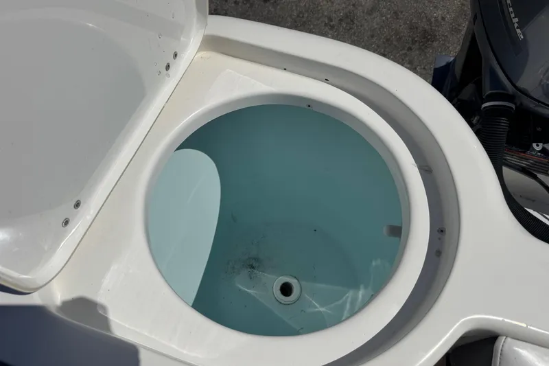 Slide: The Image of Open livewell on 2014 Tidewater 250 CC Adventure boat, showing clean interior. - 39