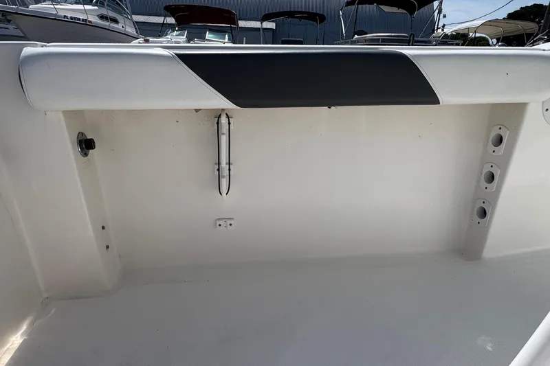 Slide: The Image of 2014 Tidewater 250 CC Adventure boat interior, featuring clean white deck and storage compartments. - 41