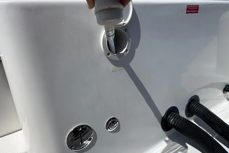 Slide: The Image of Fueling port on a 2014 Tidewater 250 CC Adventure boat, showing hose connections. - 43