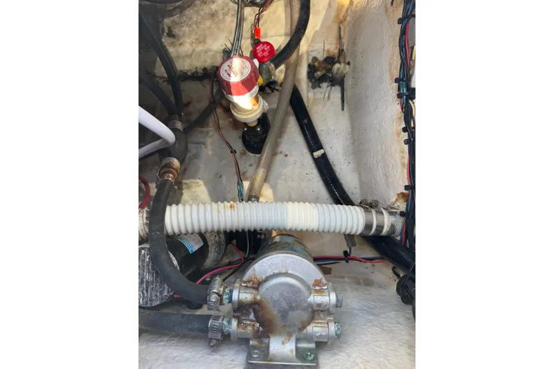 Slide: The Image of 2014 Tidewater 250 CC Adventure boat engine compartment with hoses and wiring. - 45