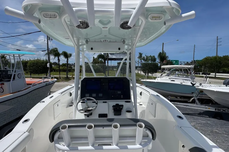 Slide: The Image of 2014 Tidewater 250 CC Adventure boat interior with steering console and rod holders. - 5