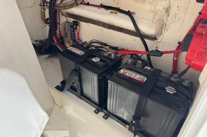 Slide: The Image of Batteries and wiring inside a 2014 Tidewater 250 CC Adventure boat compartment. - 50