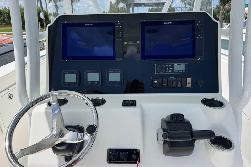 Slide: The Image of Control panel of a 2014 Tidewater 250 CC Adventure boat with dual Simrad displays. - 6