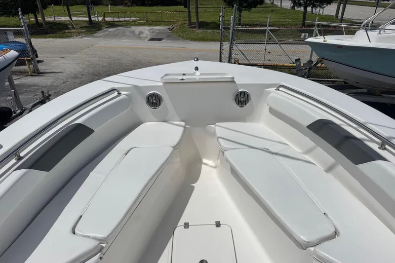 Slide: The Image of 2014 Tidewater 250 CC Adventure boat interior with white seating and stainless steel railings. - 7