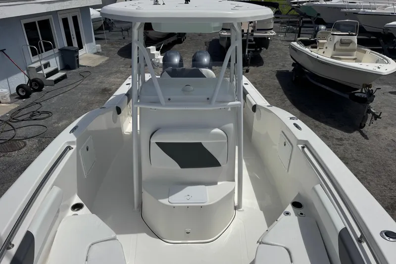 Slide: The Image of 2014 Tidewater 250 CC Adventure boat, white interior, docked at a marina. - 8
