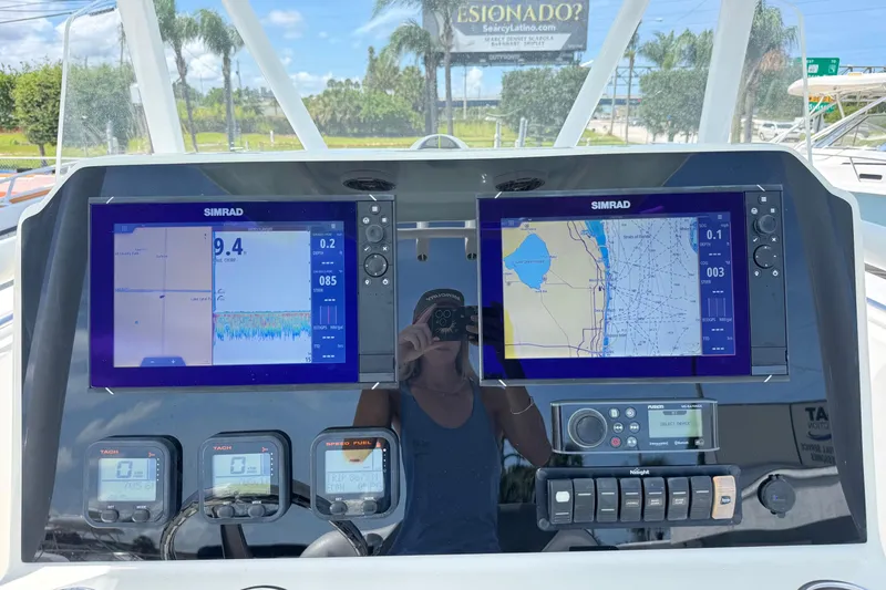 Slide: The Image of Control panel of a 2014 Tidewater 250 CC Adventure boat with navigation screens. - 9