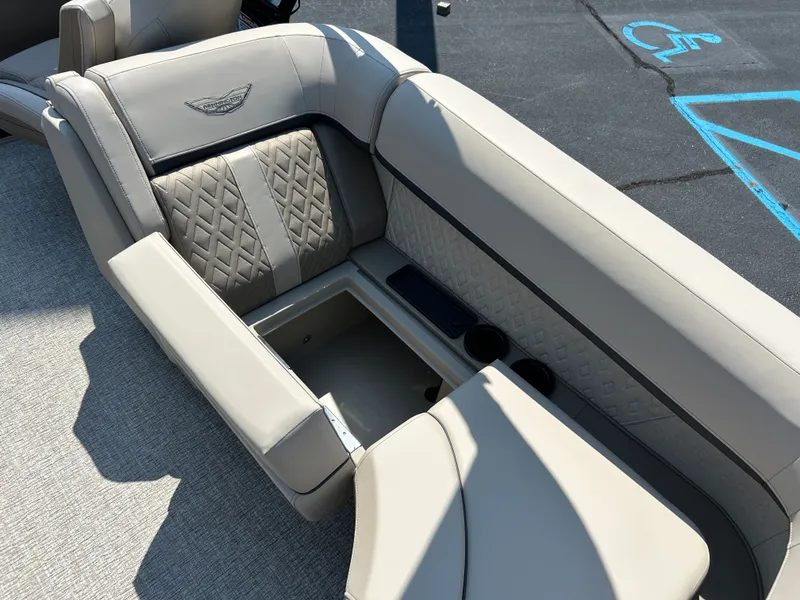 Slide: The Image of The image shows a beige bench seat on a boat with quilted pattern and cup holders. - 11