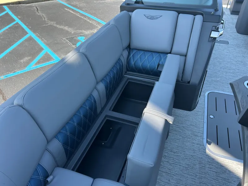 Slide: The Image of The image shows a luxurious gray boat seat with blue accents and storage space underneath. - 34