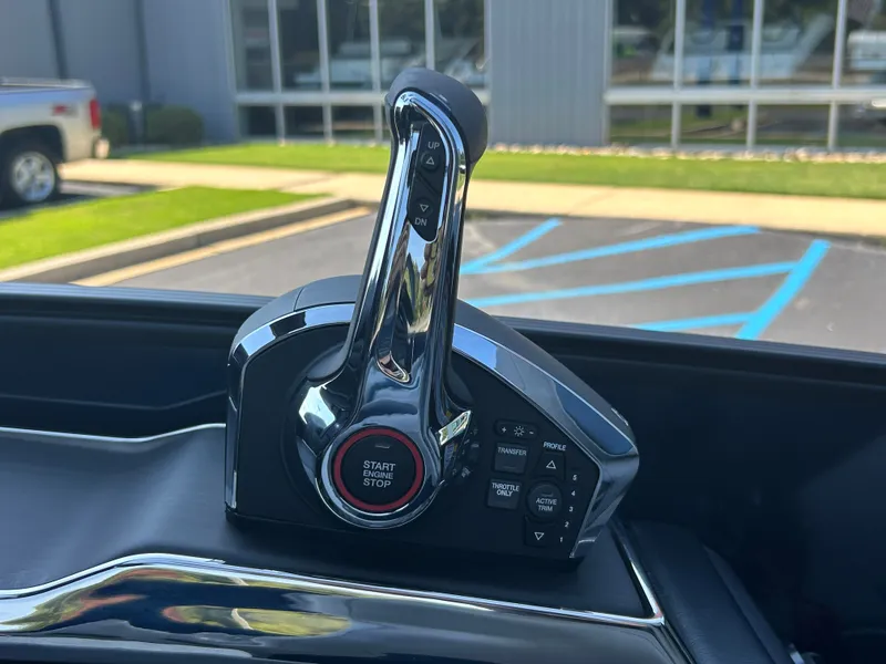 Slide: The Image of Close-up of a modern boat throttle with a start-stop button, surrounded by various controls. - 22