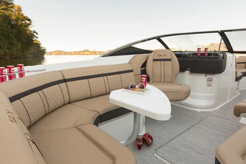 Slide: The Image of Manufacturer Provided Image: 2018 Sea Ray SLX 250 boat interior with tan seating and a small table. - 10