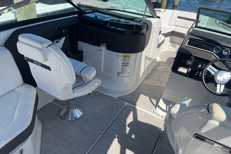 Slide: The Image of Interior of a 2018 Sea Ray SLX 250 boat with modern seating and controls. - 18