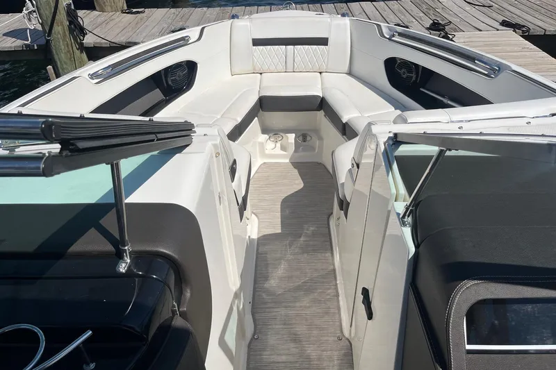 Slide: The Image of 2018 Sea Ray SLX 250 boat interior with white seating and open deck view. - 22