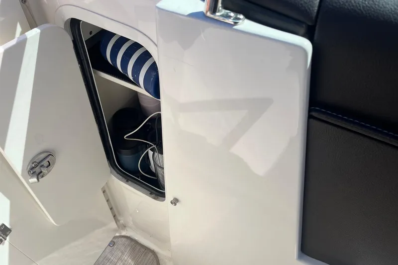 Slide: The Image of Storage compartment on a 2018 Sea Ray SLX 250 boat, featuring organized interior space. - 23