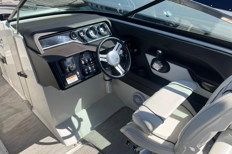 Slide: The Image of Cockpit of 2018 Sea Ray SLX 250 boat with steering wheel and controls. - 24