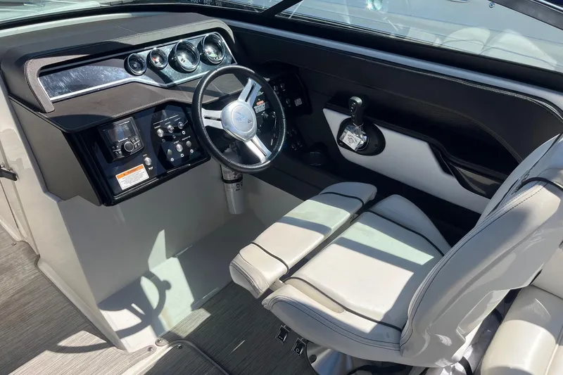 Slide: The Image of 2018 Sea Ray SLX 250 helm with modern controls and comfortable seating. - 25