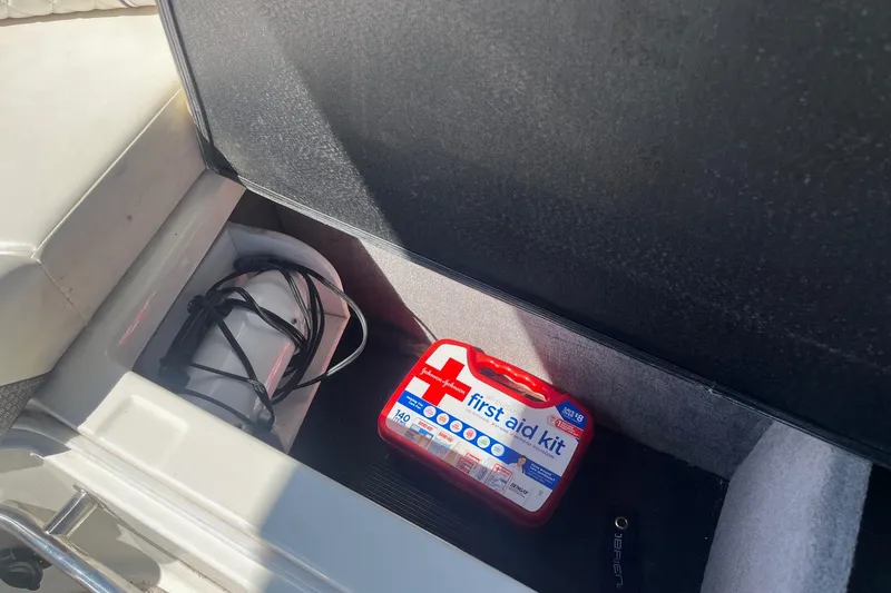 Slide: The Image of First aid kit and equipment storage in 2018 Sea Ray SLX 250 boat compartment. - 29
