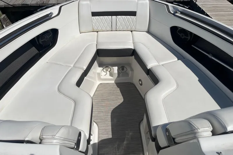 Slide: The Image of 2018 Sea Ray SLX 250 boat interior with white cushioned seating and sleek design. - 30