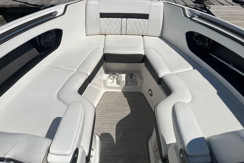 Slide: The Image of 2018 Sea Ray SLX 250 boat interior with white cushioned seating and modern design. - 31