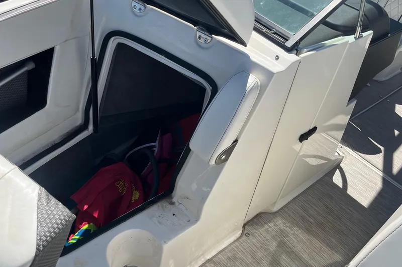 Slide: The Image of 2018 Sea Ray SLX 250 boat interior storage compartment with open hatch. - 32