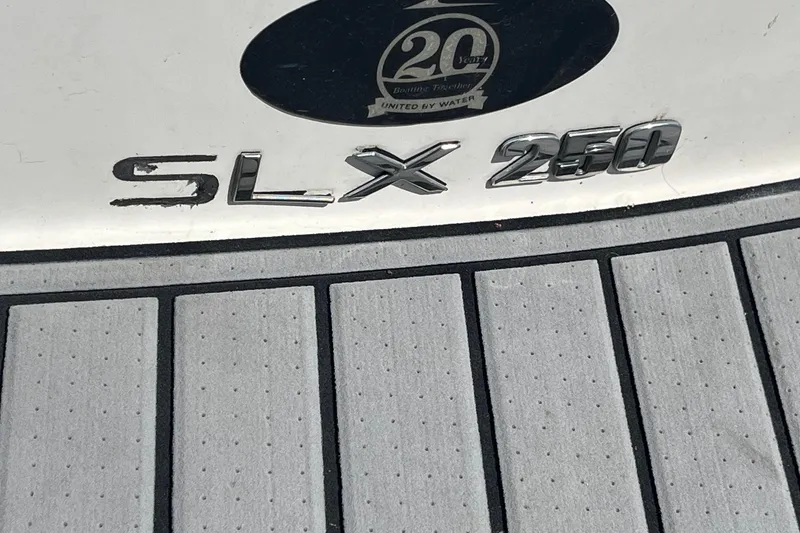 Slide: The Image of 2018 Sea Ray SLX 250 boat emblem on textured deck surface. - 36