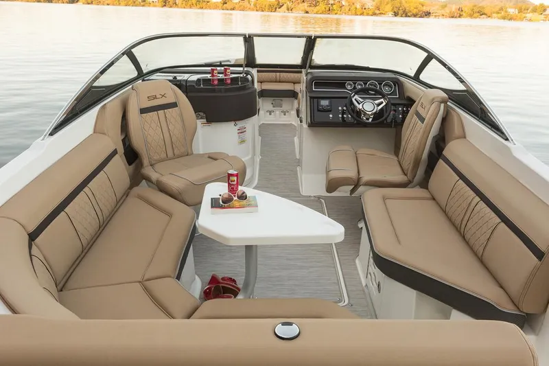 Slide: The Image of Manufacturer Provided Image: 2018 Sea Ray SLX 250 boat interior with tan leather seating and a central table. - 5