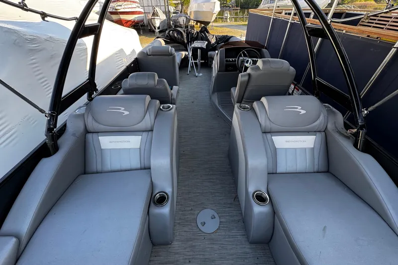 Slide: The Image of 2022 Bennington 24LX pontoon boat interior with luxurious gray seating and modern design. - 2