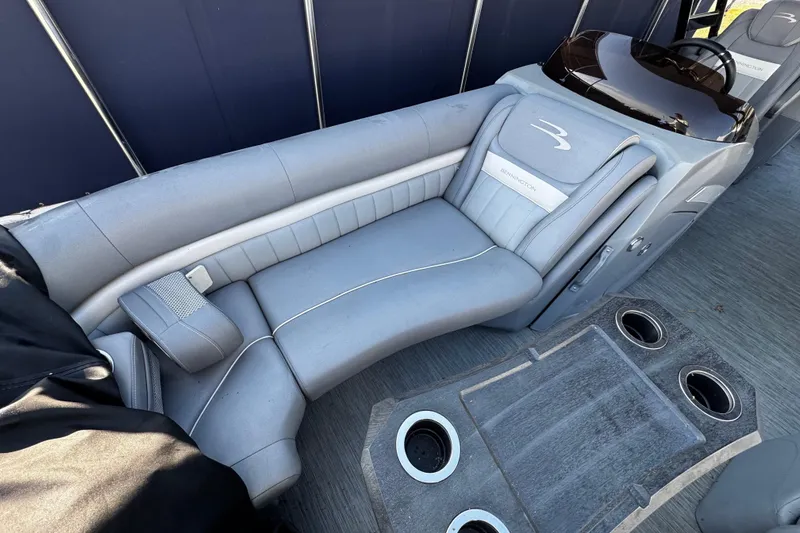 Slide: The Image of Luxurious seating on a 2022 Bennington 24LX pontoon boat with cup holders and sleek design. - 5