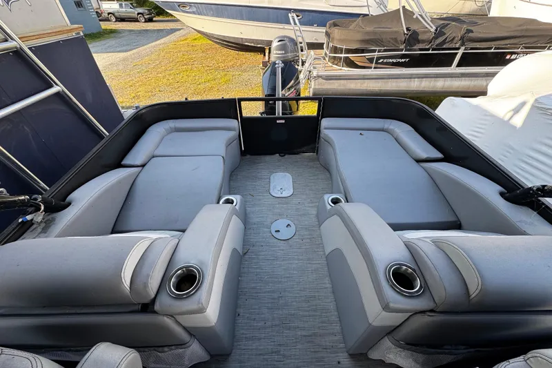 Slide: The Image of 2022 Bennington 24LX pontoon boat interior with spacious seating and cup holders. - 8